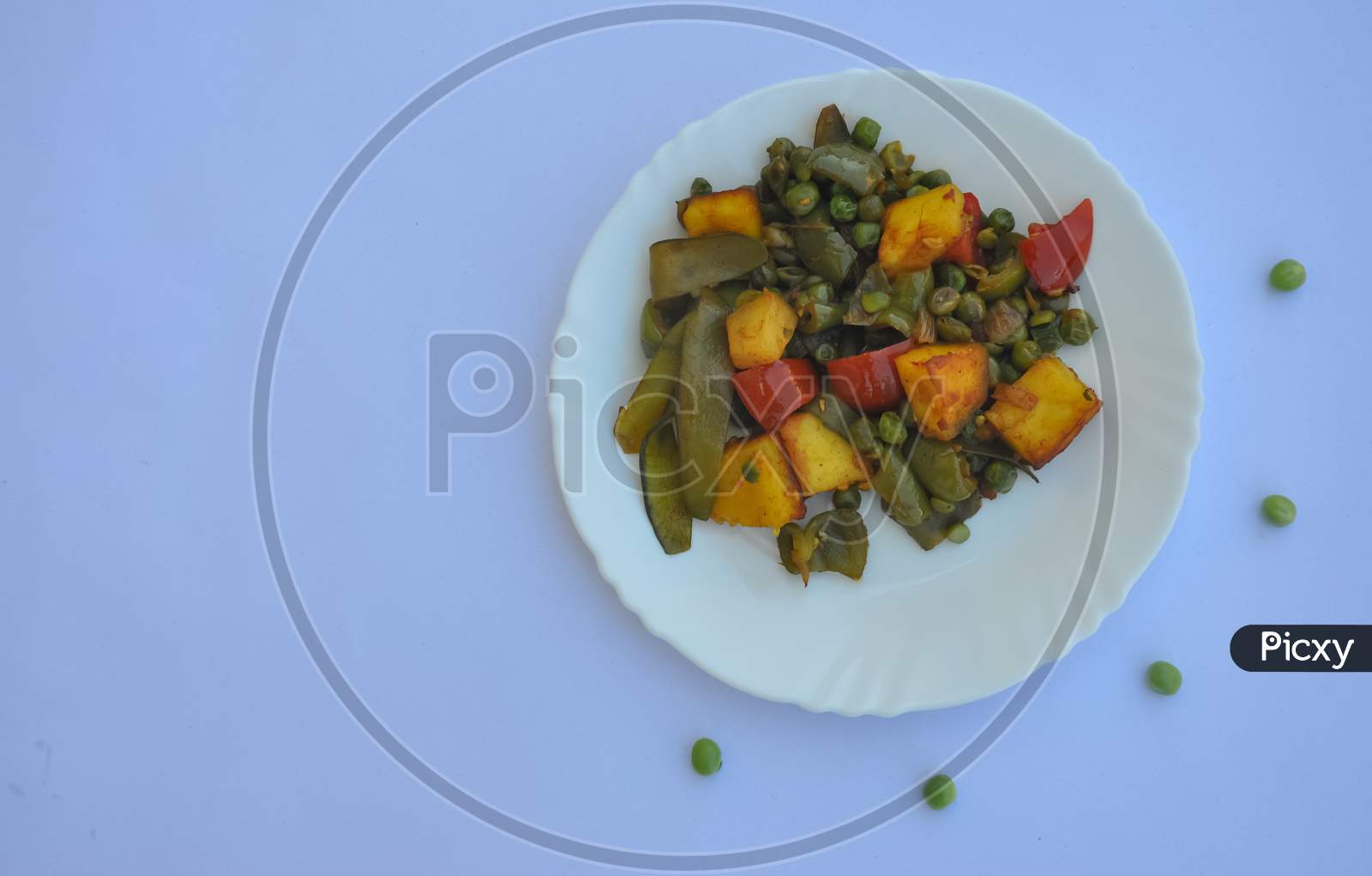 High angle view of matar paneer mix veg recipe (Indian food) over white background with copy space