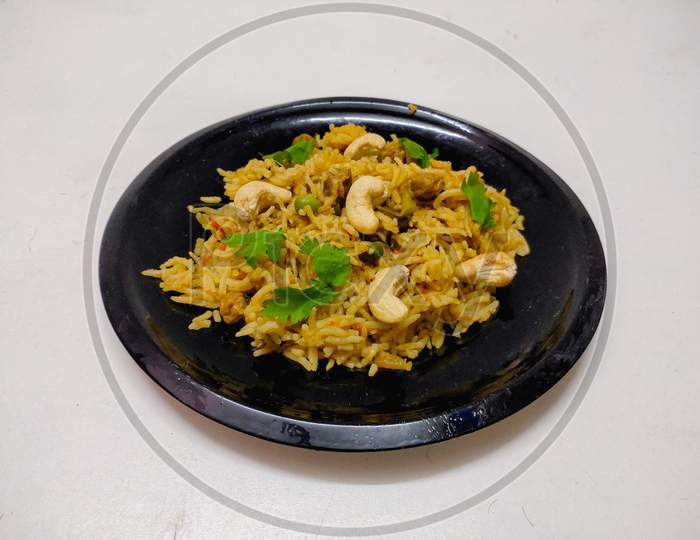 Delicious Homemade Pulao or vegetable briyani or Vegetable Rice made with Basmati rice, vegetable and spices isolated in a White background with copy space.