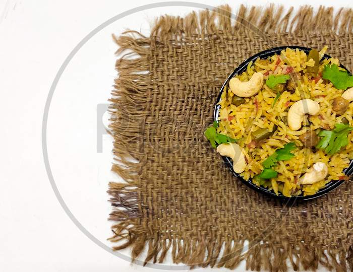 Delicious Homemade Pulao or vegetable briyani or Vegetable Rice made with Basmati rice, vegetable and spices isolated in a White background with copy space.