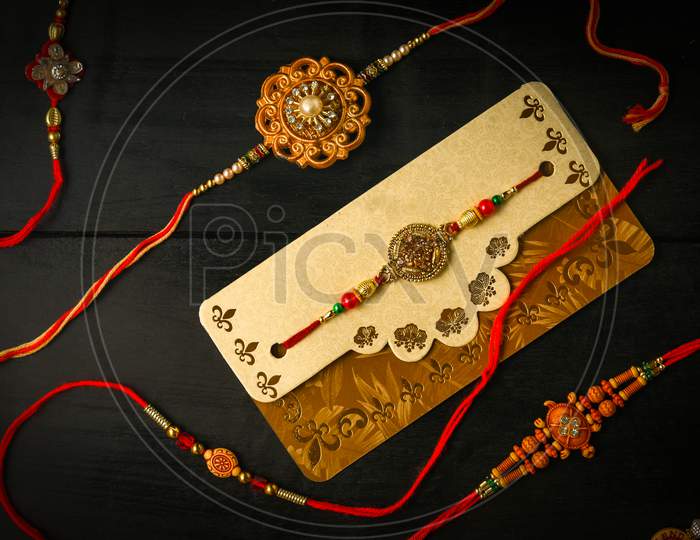 Raksha Bandhan background with an elegant Rakhi. A traditional Indian wrist band which is a symbol of love between Brothers and Sisters