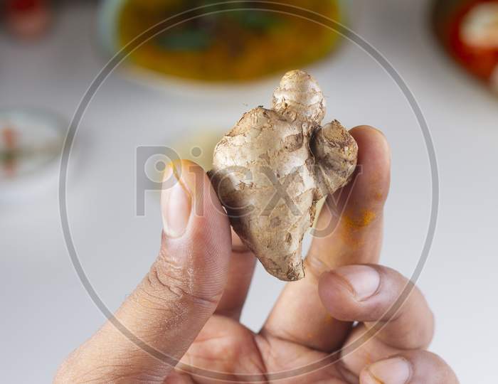 Ginger In Hand Isolated On Light Background.
