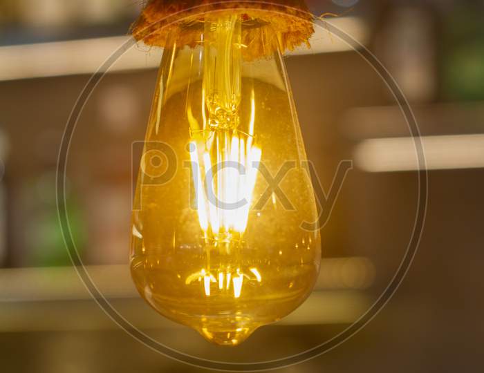 Vintage Light Bulb, Lamp Hanging With Blurred Background At Coffee Shop In India For Decorate And Background Picture. Selective Focus.