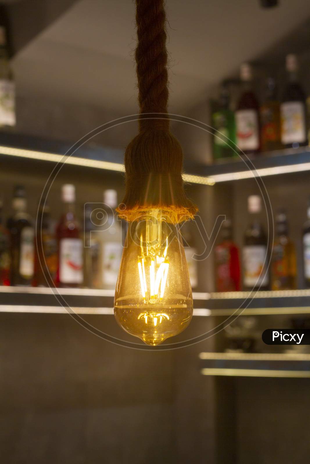 Vintage Light Bulb, Lamp Hanging With Blurred Background At Coffee Shop In India For Decorate And Background Picture. Selective Focus.