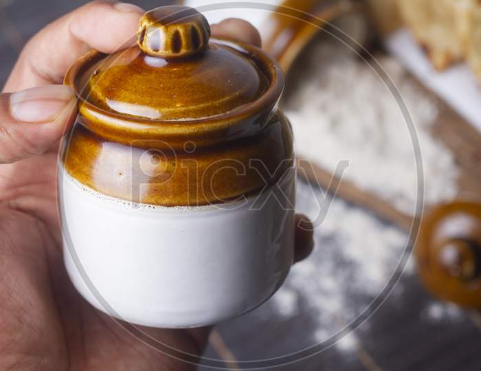 A Jar In Hand Isolated On Light Background.