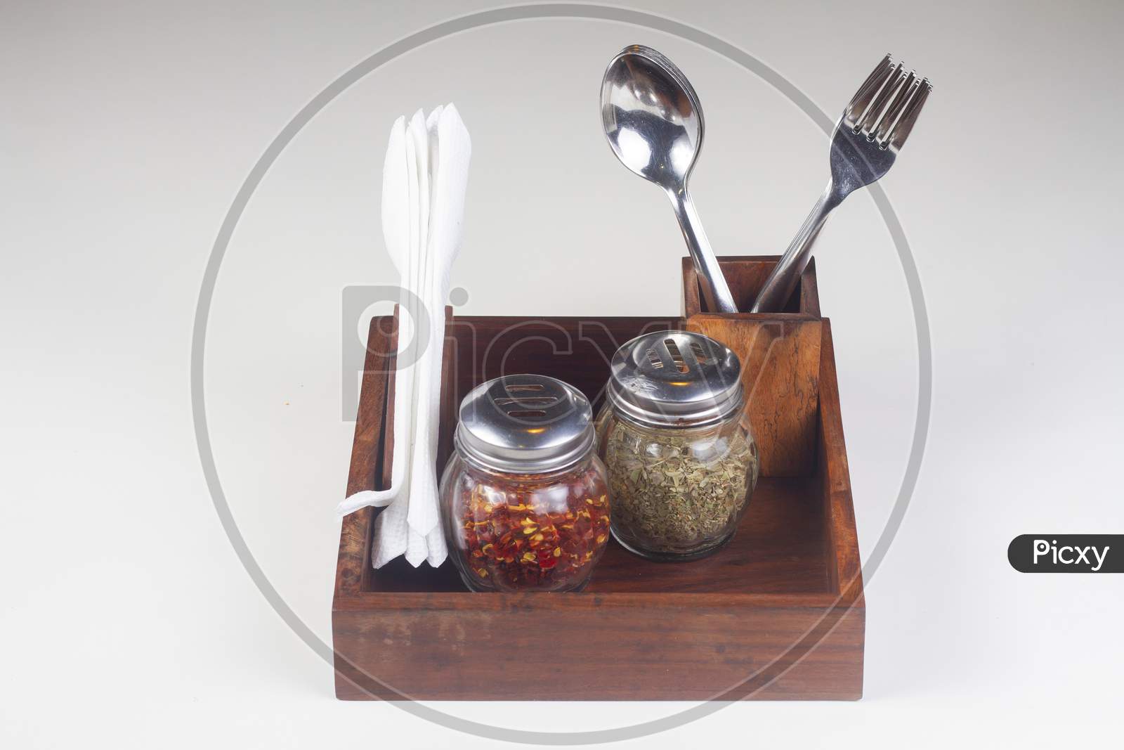Restaurant Spoon And Fork Holder. Chili Flakes, Oregano Jar And Tissue Paper Inside A Box