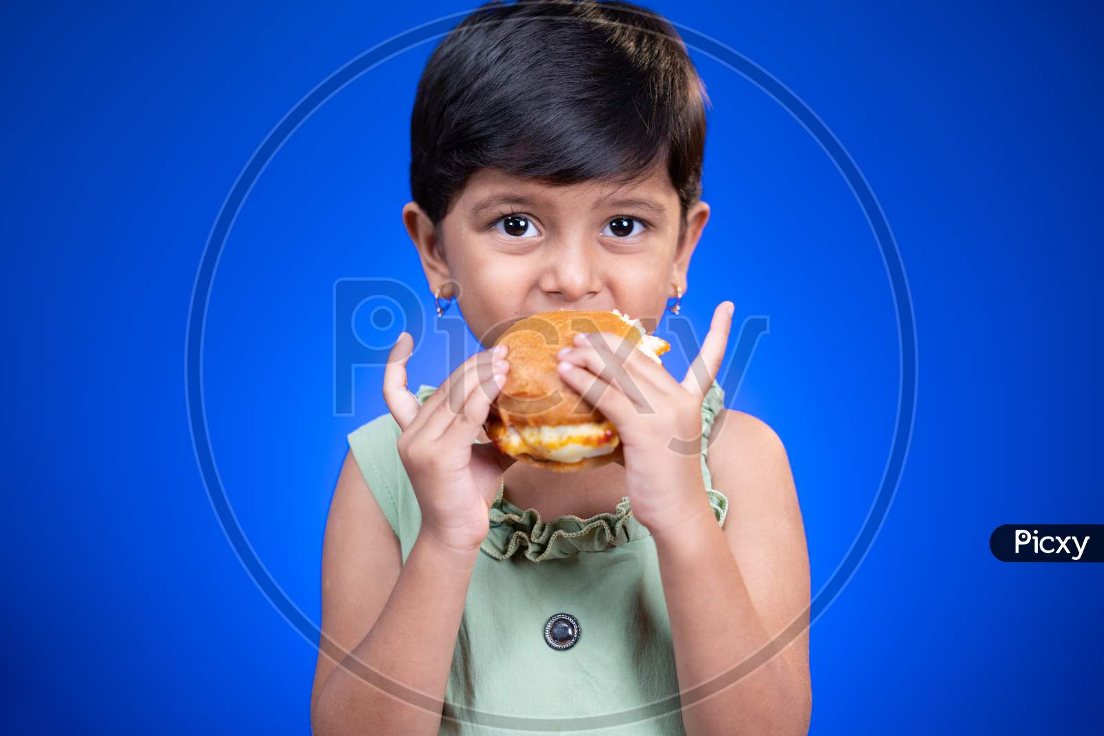 Girl Kid Enjoying Eating Of Tasty Burger On Blue Background - Concept Of Children Unhealthy Eating Habits.