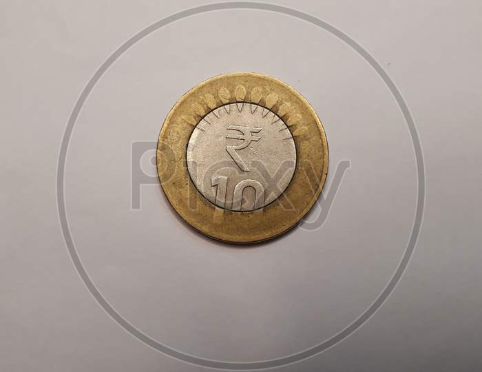 Indian currency coin 10 on white paper