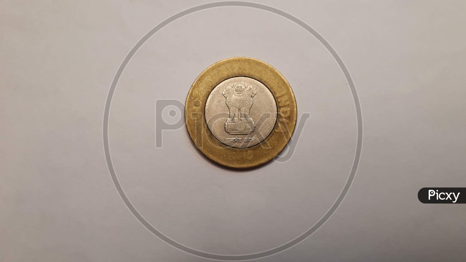 Indian currency coin 10 on white paper