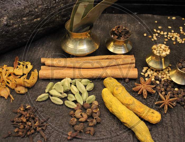 Most common and flavourful Indian Spices. Spices used in Indian food. Spices in traditional masala grinding stone