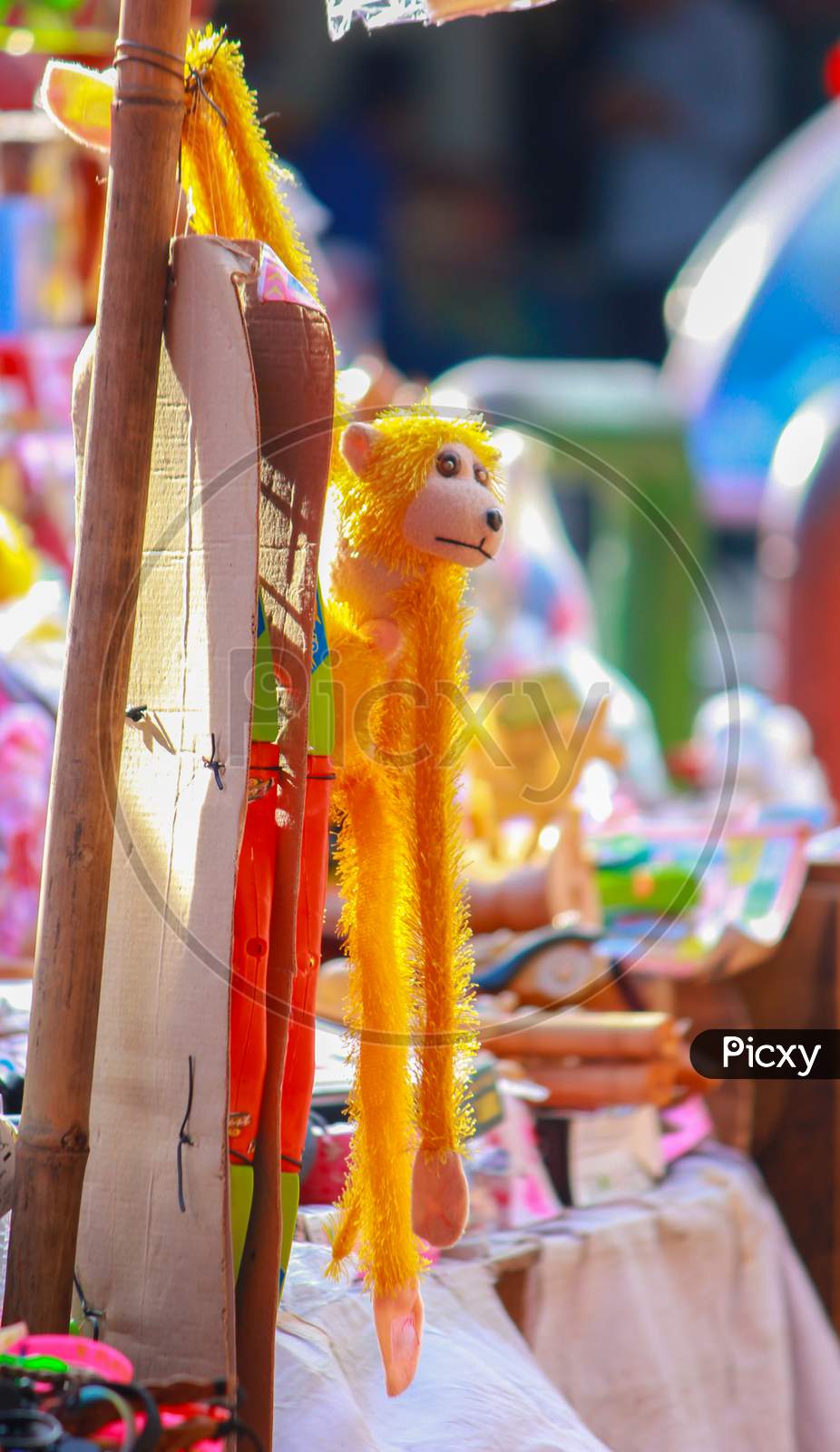 Yellow Monkey toys selling on the street of Sonargaon, Dhaka, Bangladesh in front of a world heritage site.