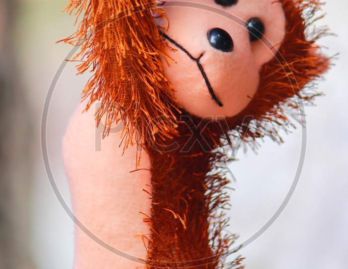 Brown color hairy monkey toy hanging at the street of Dhaka, Bangladesh