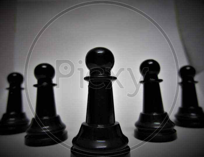 Chess pieces pawns on a white background.