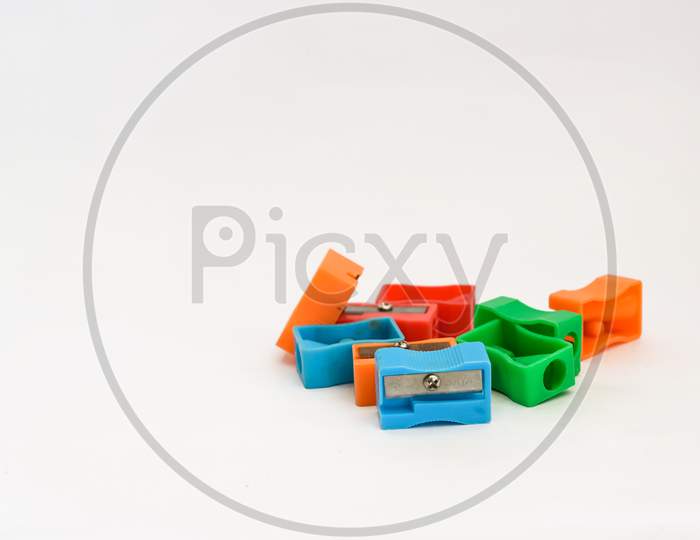 Different Colors Sharpener On White Background With Copy Space.