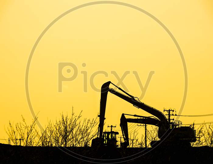 Power Shovel And Grassland Of The Silhouette