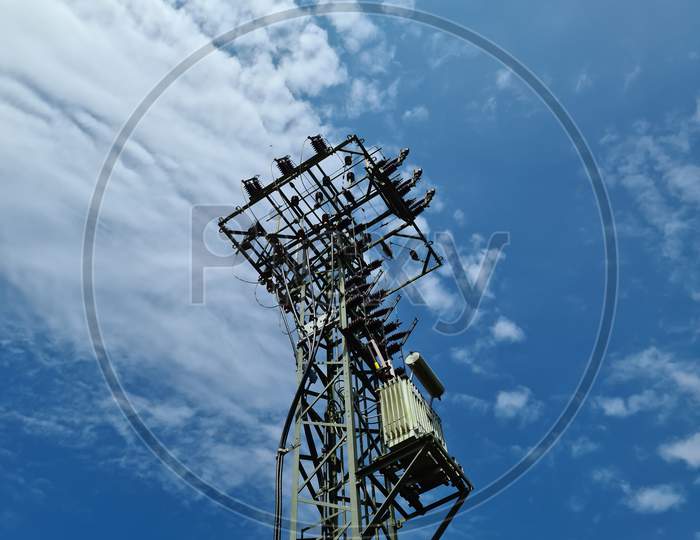Close Up View On A Big Power Pylon Transporting Electricity In A Countryside Area