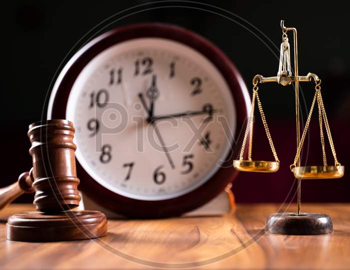 Concept Showing Of Problems With Legal System, Delay Or Slow In Judicial Justice System By Using Judge Hammer, Balance Scale And Wall Clock.
