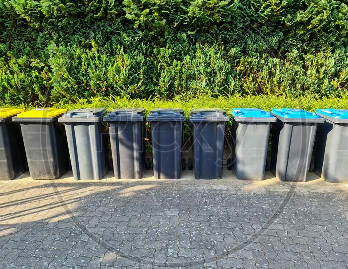 Lots Of Garbage Cans Standing In A Row