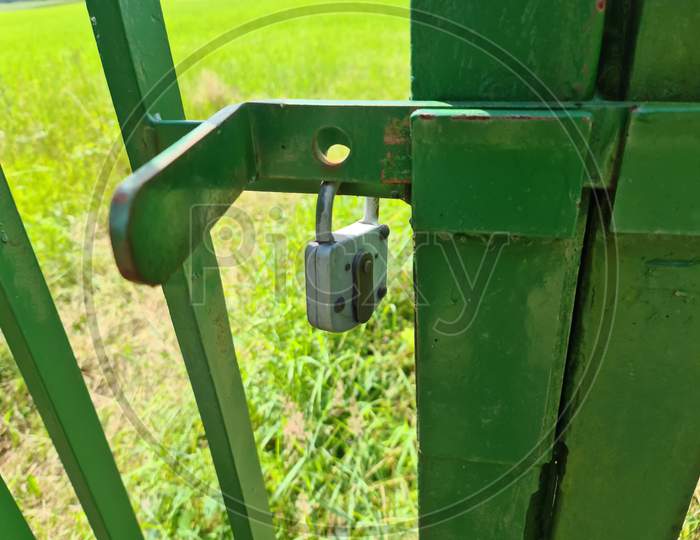 Close Uo Of A Lock At A Close Metal Gate.
