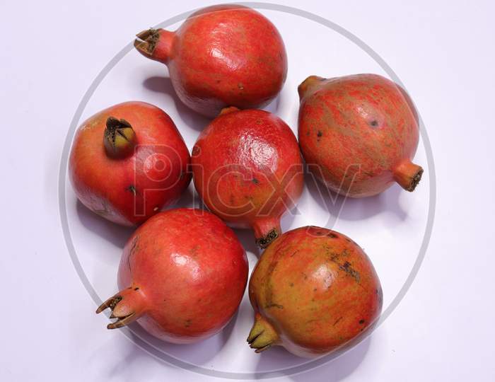 Fresh Pomegranate Fruits Isolated on White Background