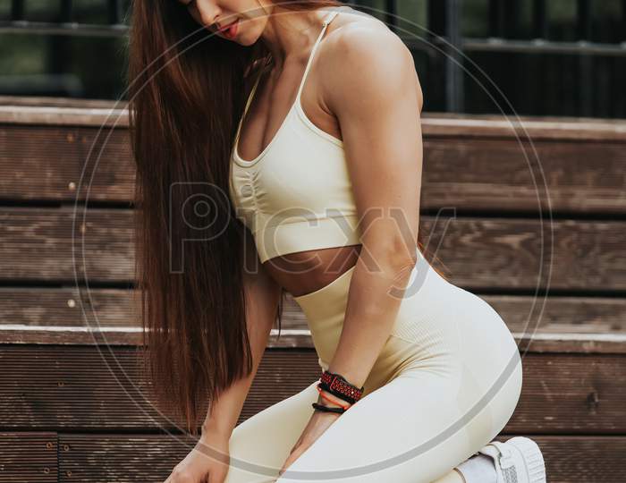 Attractive Young Woman In Sportswear Posing. Sensual Brunette Woman With Perfect Body. Sport Activity Lifestyle Concept