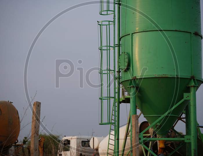 Asian Concrete Mixer Machine Presenting Around Sky Industrial Background.