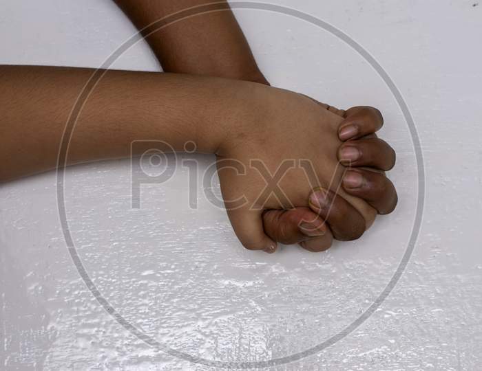 A Male Hand Holding A Child Hand To Give Him Support.