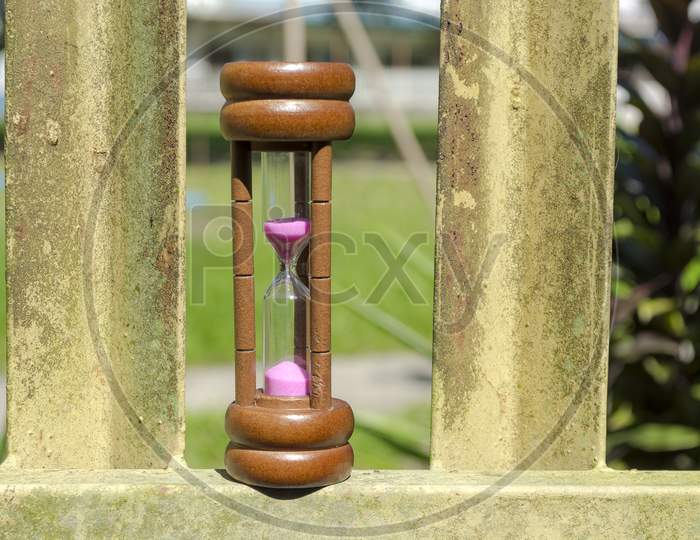 Hourglass As Time Passing Concept For Business Deadline With Nature Background