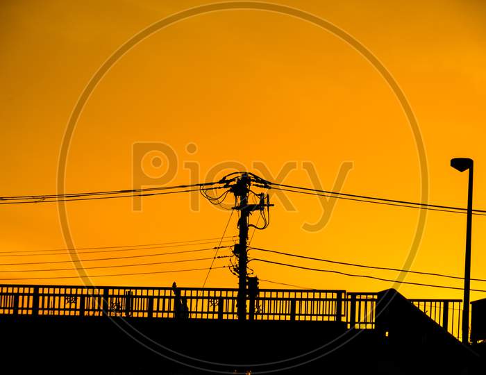 Silhouette Of Sunset And Electric Wire And Building