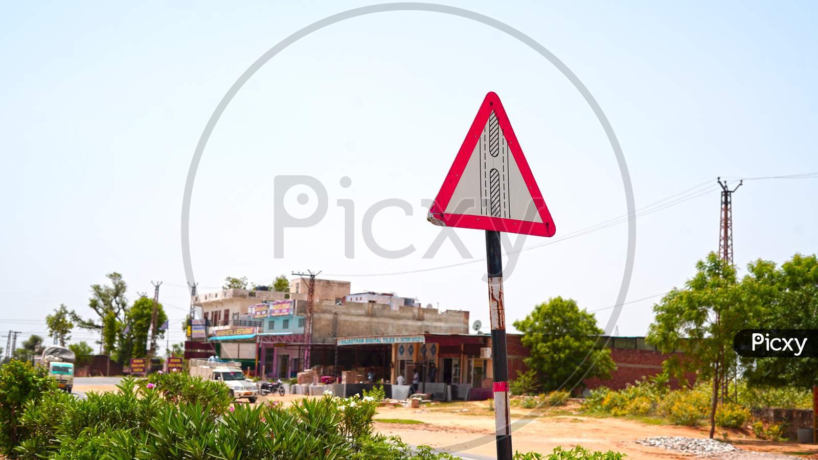Traffic Sign To Cross The Road Wit A Pillar. Indian Road Sign And Symbol Board With Green Plain Background.