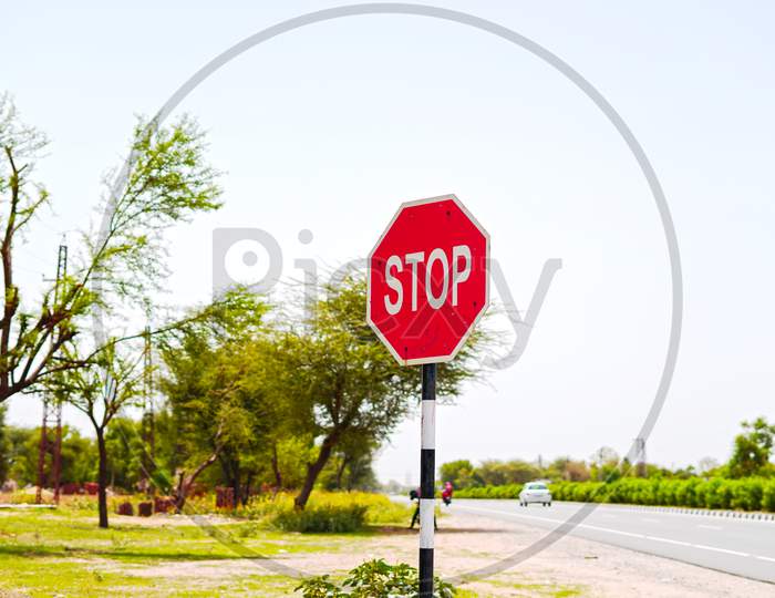 " Stop And Give Away Sign Board " Closeup Shot With Attractive White Written Text. Along Side Road Symbol And Signs Concept.