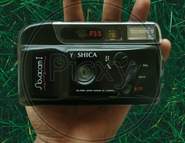 Holding an Old Yashica SLR Camera