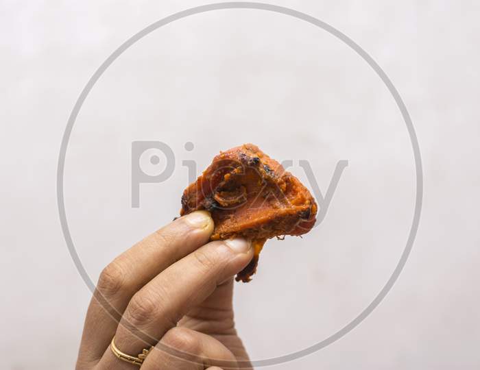 Delicious Juicy Grilled Chicken In A Female Hand.