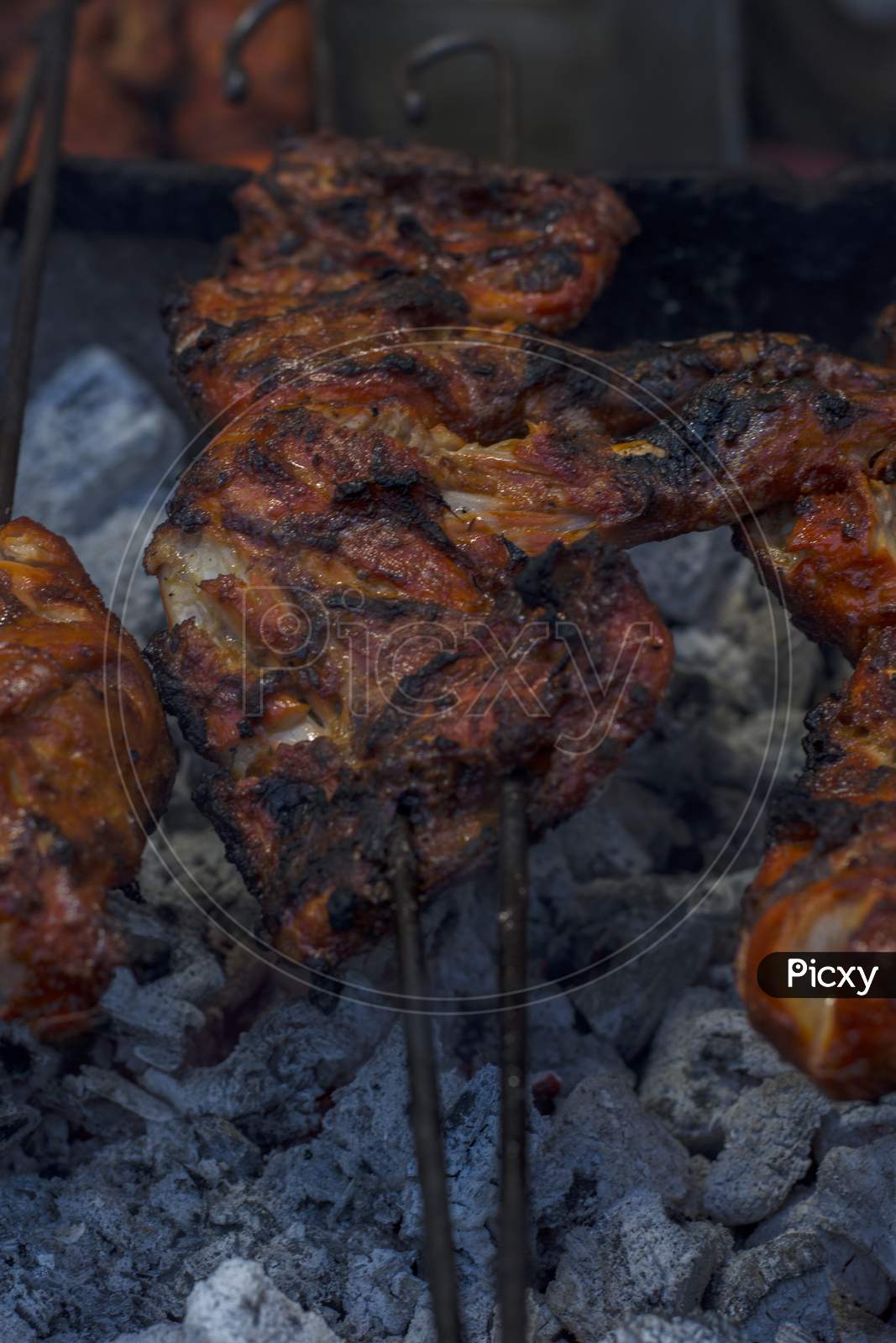 Tasty Whole Chicken On Grill With Fire. Selective Focus