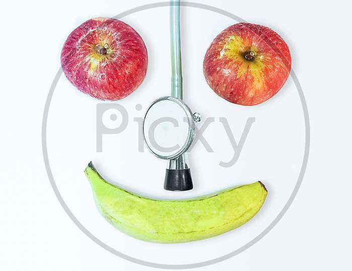 Two Apples A Stethoscope And A Bananal.Happy Health .