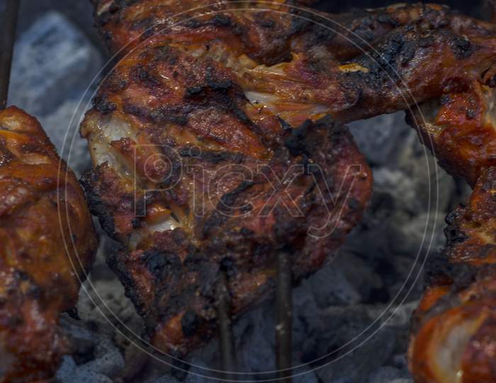 Tasty Whole Chicken On Grill With Fire. Selective Focus