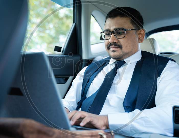 Businessman Working On Laptop While Travelling In Car - Concept Of Successful Business, Modern Lifestyle, Internet, Technology And CommunicationSho