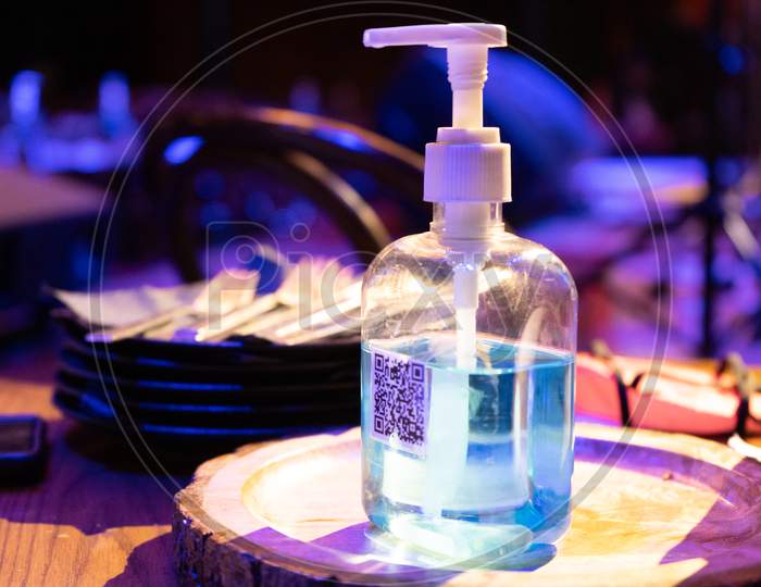 Sanitizer Bottle With Qr Code For Digital Menu Being Scanned On Mobile Phone Showing The New Normal As Clubs Bars Pubs Restaurants Open Up Post The Coronavirus Covid19 Pandemic