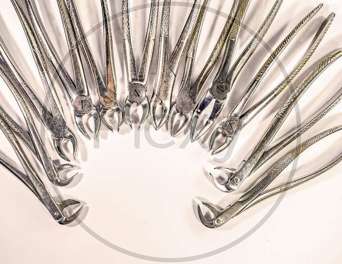 Dental Instruments Arranged On White Table - Isolated.