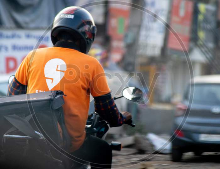 Bike Rider With Helmet And A Swiggy Tshirt Showing The Rapid Growth Of Food Delivery E-Commerce Startups Unicorns Decacorns And The Workers Who Are Provided Jobs By Them