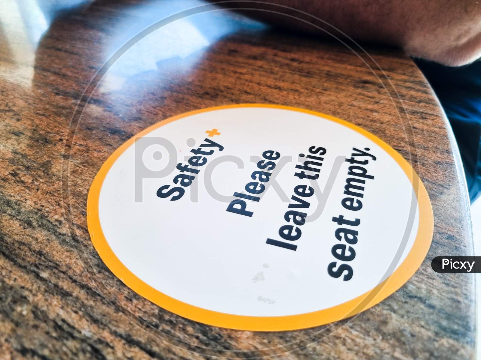 Sticker On Table Showing Mandatory Safety And Hygeine Regulations During The Pandemic On Social Distancing And Leaving Spaces And Seats Empty