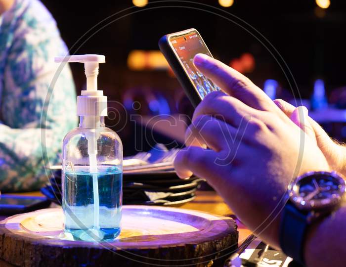 Sanitizer Bottle With Qr Code For Digital Menu Being Scanned On Mobile Phone Showing The New Normal As Clubs Bars Pubs Restaurants Open Up Post The Coronavirus Covid19 Pandemic