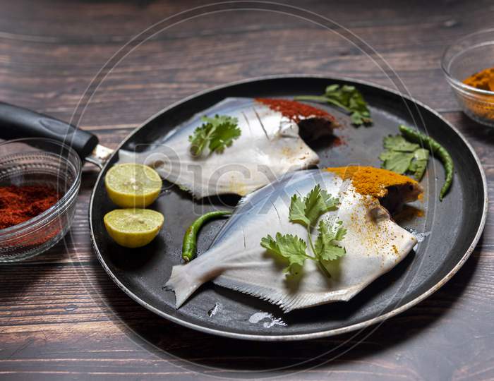 Raw fish on a cooking pan
