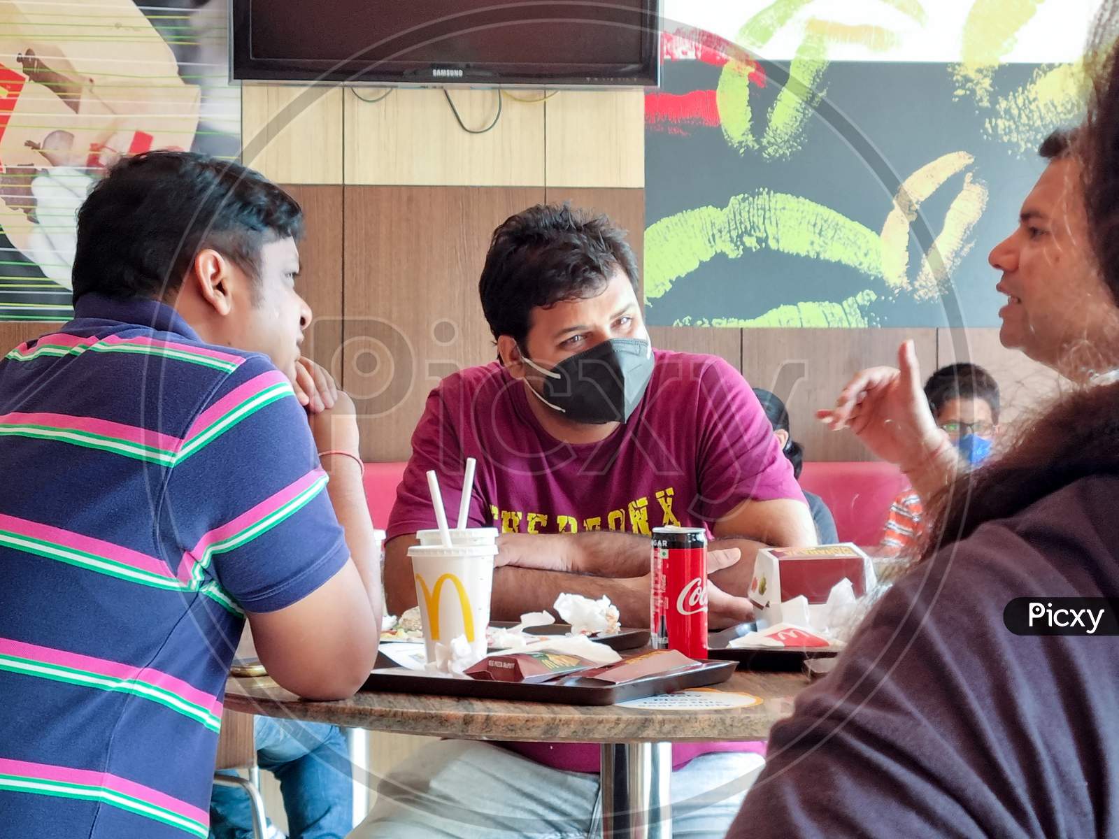 Indian Men People Socializing Relaxing And Enjoying In A Restaurant Mcdonalds While Wearing A Mask During The Coronavirus Pandemic