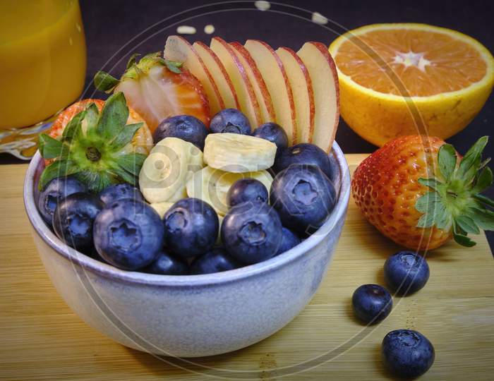 Healthy Breakfast With Fresh Fruits And Juice. Bowl Of Colorful Fruits.