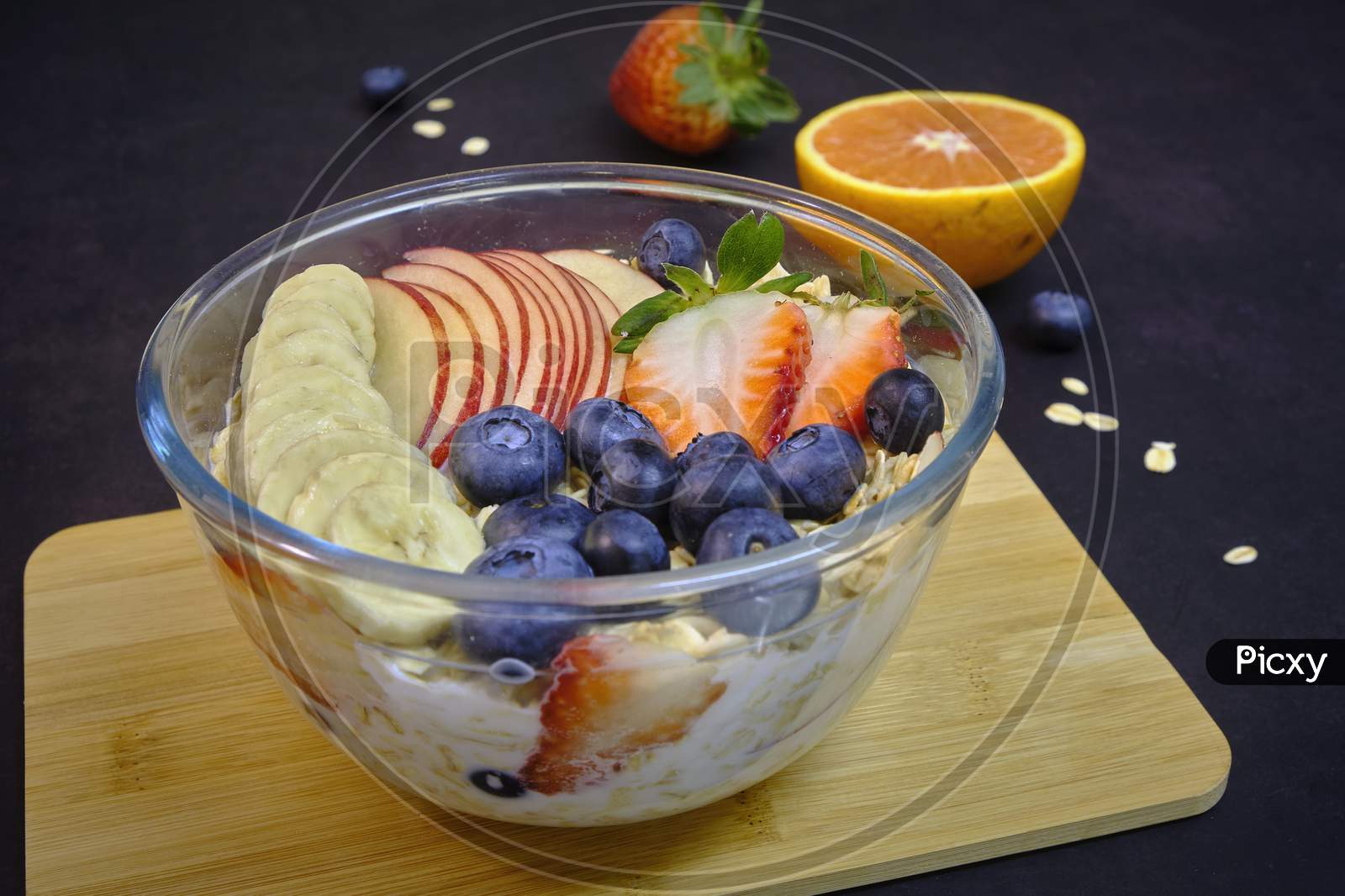 Healthy Breakfast With Fresh Fruits. Bowl Of Colorful Fruits And Oats.