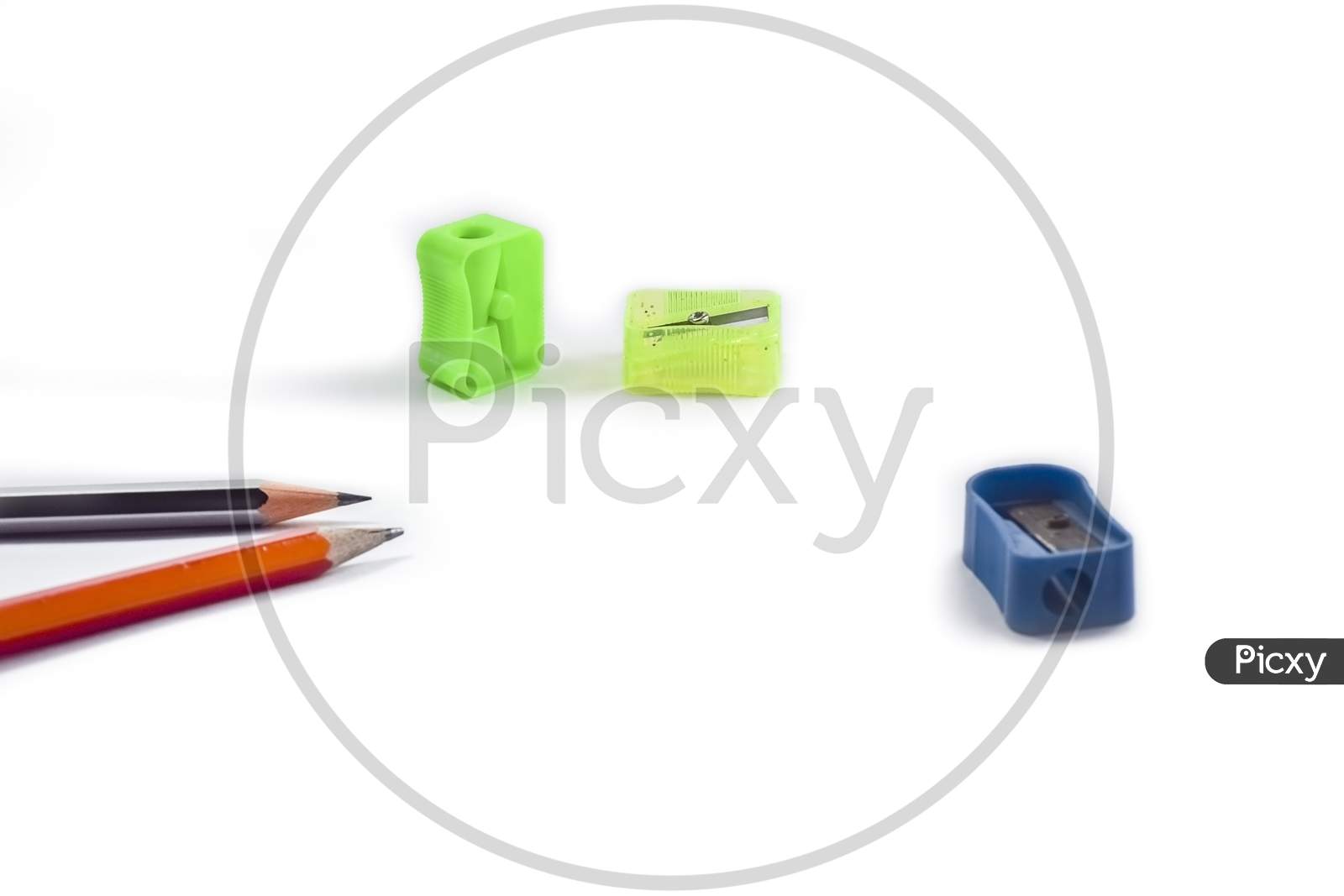 Back To School Concept- A Pencil,Erasor, Sharpner An Cut Foil Of The Pencil On White Table With Or Without Spectacles Not Properly Arranged Isolated.