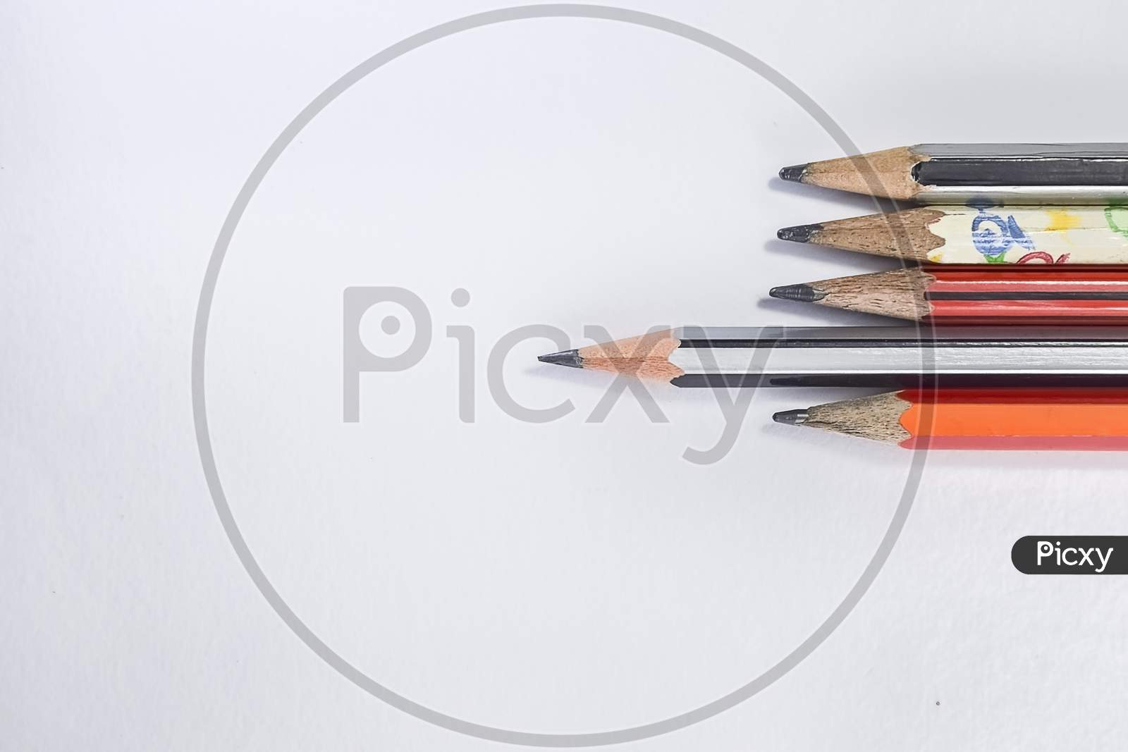 Back To School Concept- A Pencil,Erasor, Sharpener An Cut Foil Of The Pencil On White Table With Or Without Spectacles Not Properly Arranged Isolated.
