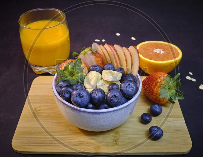 Breakfast With Fresh Fruits And Juice. Bowl Of colorful Fruits.