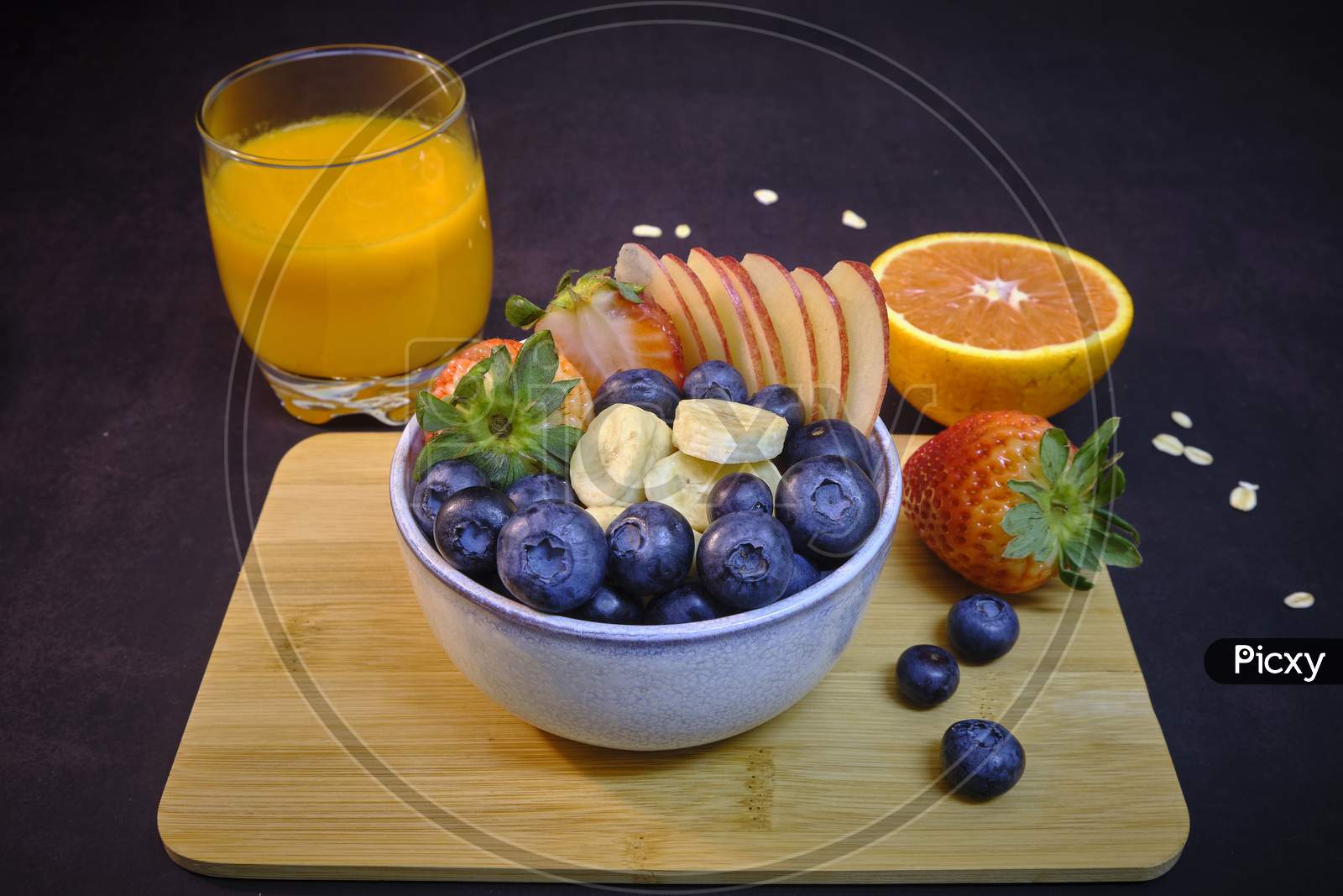 Breakfast With Fresh Fruits And Juice. Bowl Of colorful Fruits.