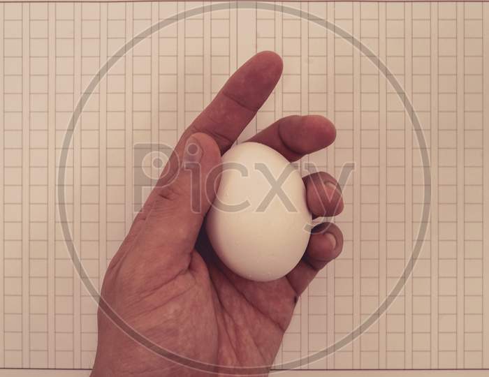 Hand Holding The Original Paper And Eggs
